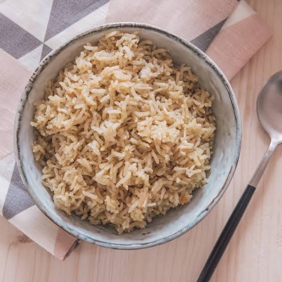 A bowl of cooked organic long grain brown rice with light, separate grains